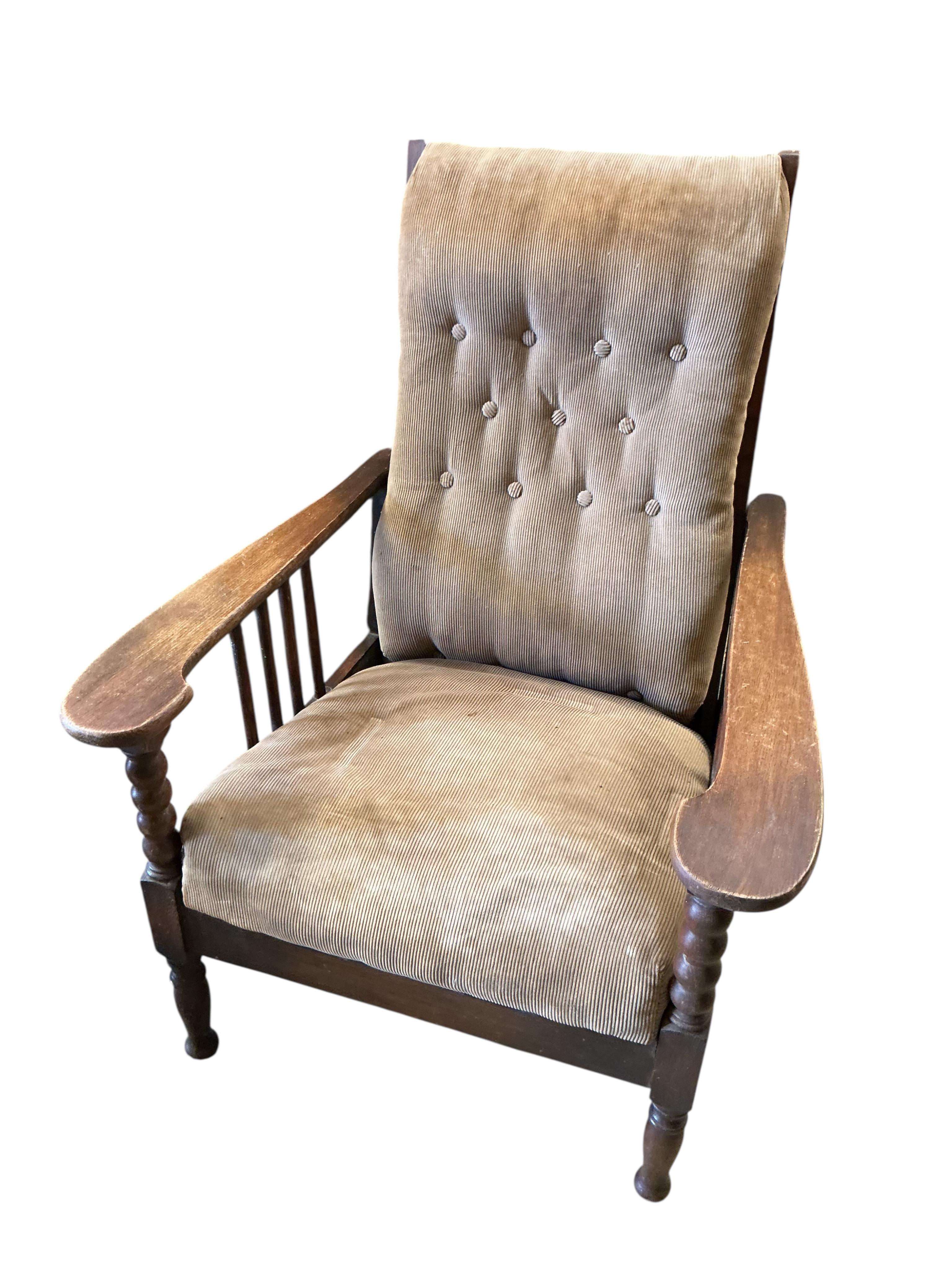 A pair of Liberty style Arts and Crafts oak reclining armchairs and an oak octagonal occasional table
